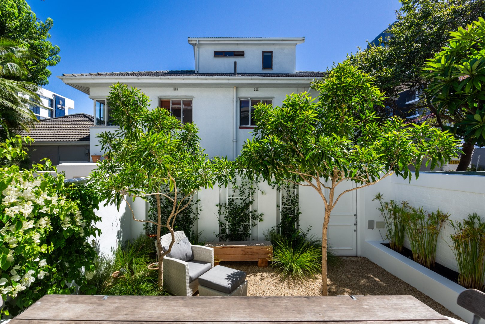 Large House with green garden and blue skies